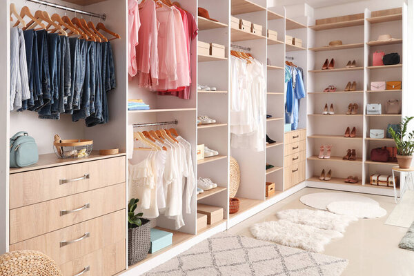 Modern wardrobe with stylish spring clothes and accessories