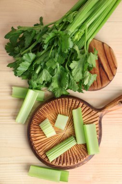 Tahta zemin üzerinde taze yeşil kereviz olan tahtalar.