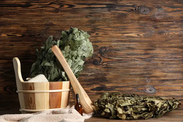 Stock image Different accessories for sauna and bottle of essential oil on wooden background