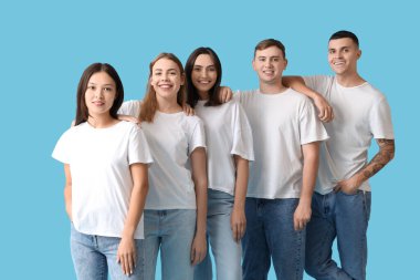 Mavi arka planda şık kotlu bir grup genç.