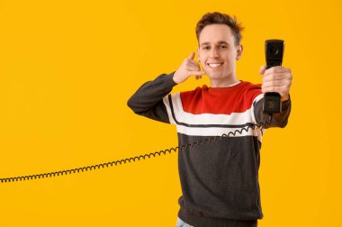 Cool young man with receiver showing 