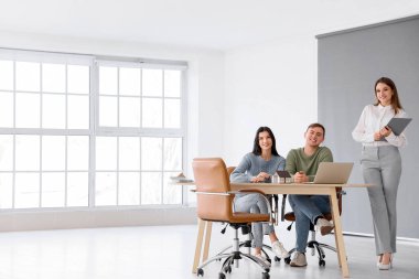 Real estate agent working with couple in office