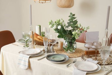 Beautiful table setting with eustoma flowers for wedding celebration in room