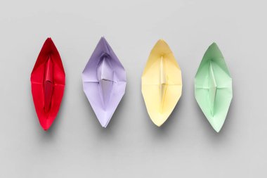 Gri arkaplanda renkli origami tekneleri