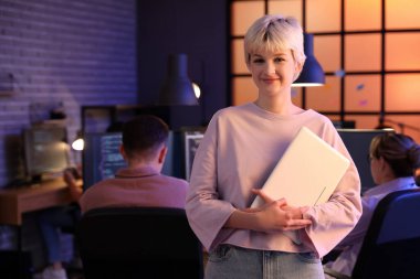 Geceleri dizüstü bilgisayarı olan genç bir programcı.