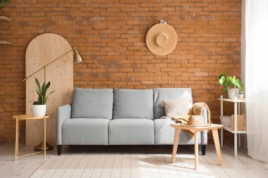 Interior of living room with cozy grey sofa and coffee table