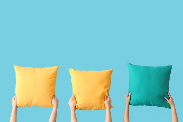 stock image Women with bright pillows on blue background