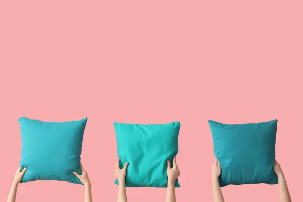 stock image Women with bright blue pillows on pink background