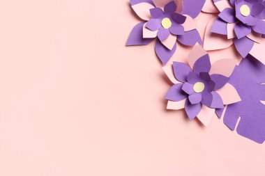 Pembe arka planda yaprakları olan renkli origami çiçekleri