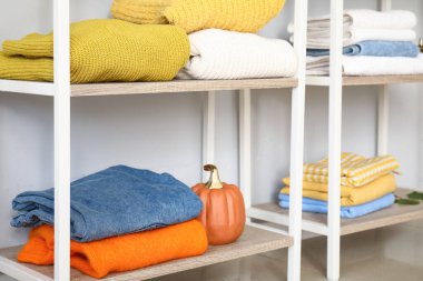 Odanın duvarında temiz kıyafetlerle dizilin, yakın plan.