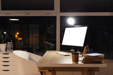 Nurse's workplace with computer at hospital in evening