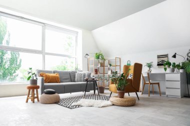 Oturma odasının içinde kanepe, koltuk ve cadının sihirli özellikleri var.