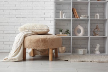 Ekoseli, yastıklı ve raflı pouf oturma odasının iç tarafında.