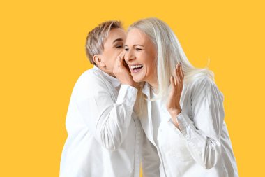 Sarı arka planda olgun kadınların dedikodusu.