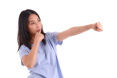 Young Asian woman practicing martial arts on white background clipart