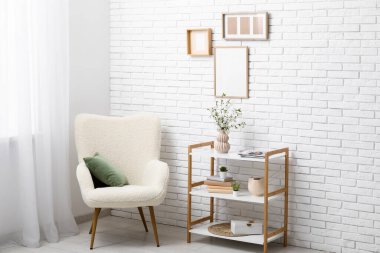 Şık bir oturma odasının içindeki raflarda çiçek açan dallar.