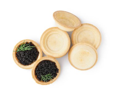 Tasty tartlets with black caviar on white background