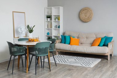 Rahat kanepesi, yemek masası, sandalyeleri ve halısı olan güzel bir oturma odası.