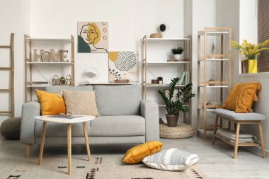 Kanepesi ve raf üniteleri olan rahat bir oturma odası.