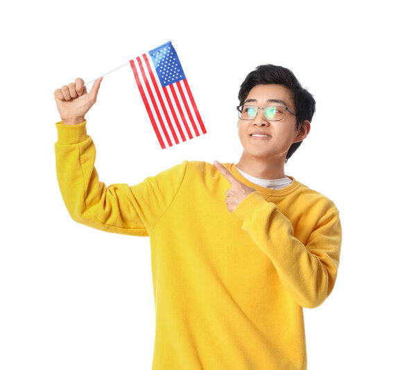 Young Asian man pointing at USA flag on white background