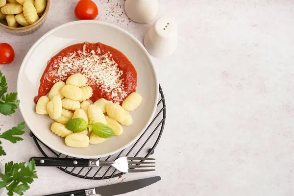 stock image Plate of tasty gnocchi with tomato sauce and cheese on white background