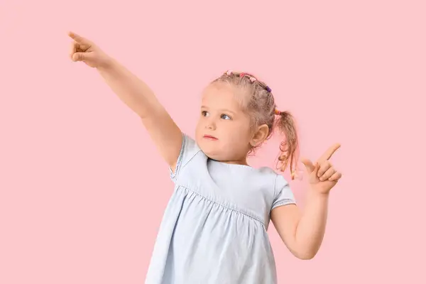 stock image Funny little girl showing loser gesture on pink background