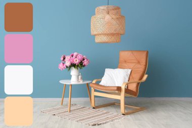 Şık oturma odasındaki koltuğun yanındaki masada pembe şakayık çiçekli vazo. Farklı renk desenleri