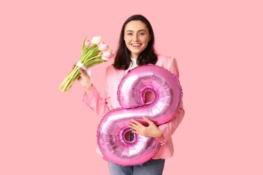 8 numaralı figür şeklinde balonu ve pembe arka planda bir buket lalesi olan güzel genç bir kadın. Uluslararası Kadınlar Günü