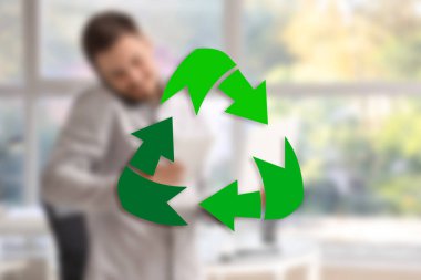 Recycling symbol and businessman in office clipart