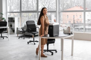 Shredder 'ı kullanarak belgeleri yok eden genç sekreter.