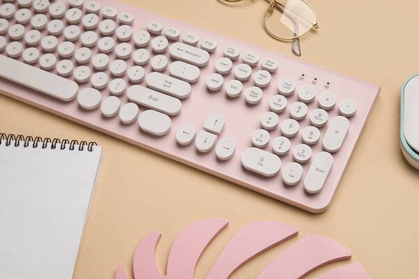 Современная клавиатура и ноутбук на цветном фоне