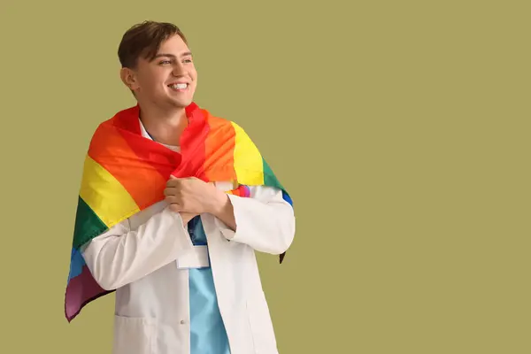 stock image Male dentist with LGBT flag on green background