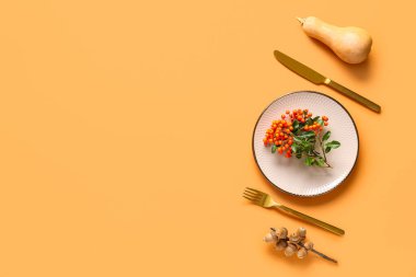 Balkabağı, deniz dikenleri ve turuncu arka planda kestane ile sonbahar masası.