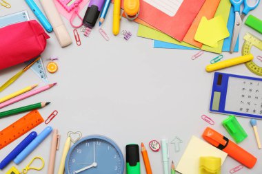 Alarm saatinden yapılmış çerçeve ve gri arkaplandaki farklı kırtasiye