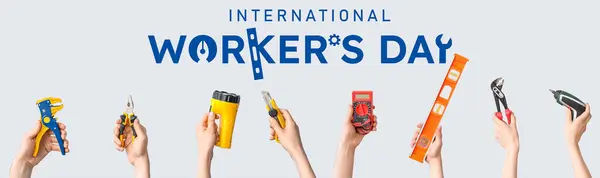 stock image Festive banner for International Workers' Day with hands holding construction tools