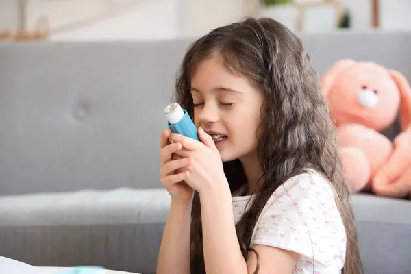 stock image Little girl using inhaler at home, closeup