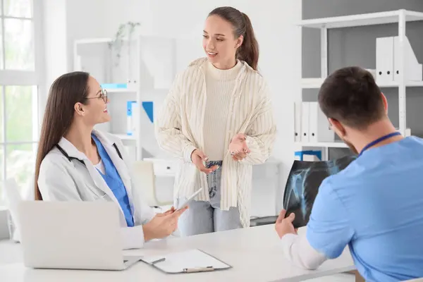 stock image Young doctors working with patient in clinic