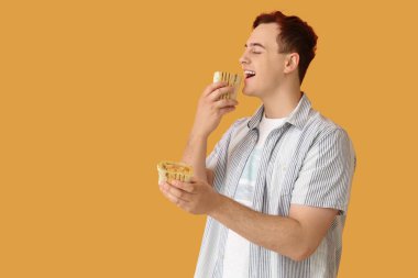 Bej arka planda lezzetli donör kebabı yiyen genç bir adam.