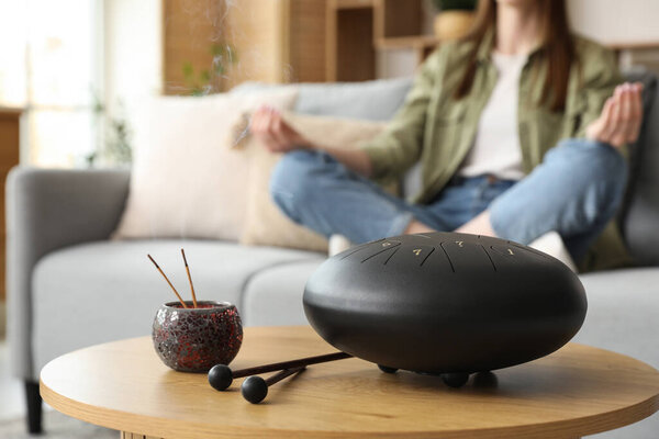Glucophone with aroma sticks on table in living room, closeup