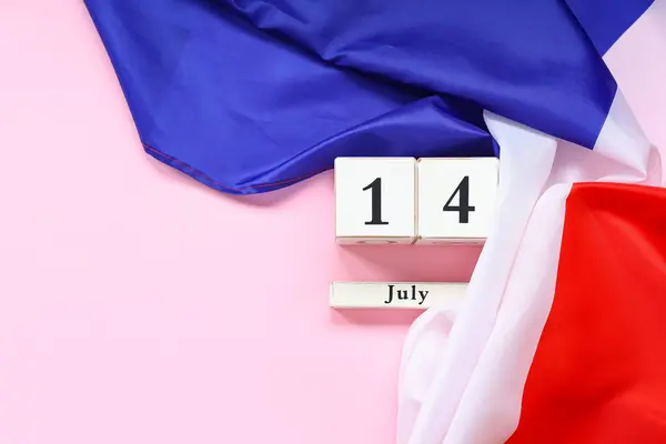 stock image Flag of France and cube calendar with date 14 JULY on pink background. Bastille Day celebration