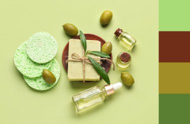 Sabun çubuğu, yeşil arka planda gerekli yağ ve makyaj süngerleri. Farklı renk desenleri