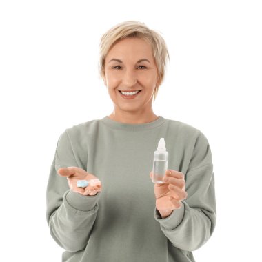 Kontak lens kutusu ve solüsyonu beyaz arkaplanda olan olgun bir kadın