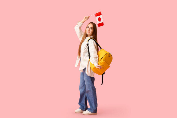 Female student with backpack and flag of Canada on pink background