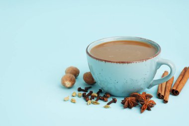 Mavi zemin üzerinde farklı baharatlar olan lezzetli bir masala çayı.