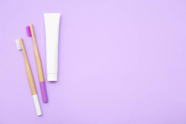 Diş fırçaları ve arkaplanda diş macunu.