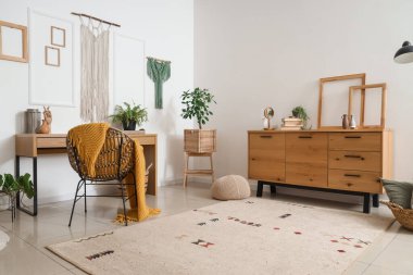 Interior of cozy office with workplace and wall tapestries