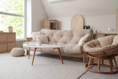 Interior of stylish living room with white sofa, armchair and coffee table