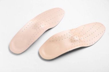 Beyaz arkaplanda deri ortopedik tabanlar