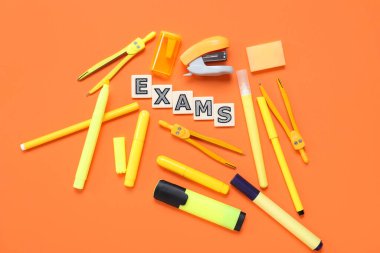 Kelime ExAMS ile kompozisyon ve turuncu arkaplan üzerinde farklı kırtasiye