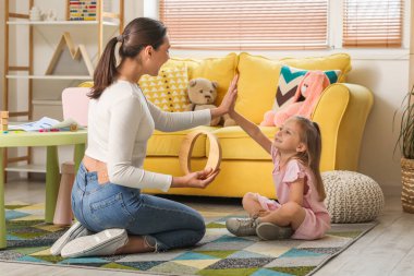 Küçük tatlı bir kızı olan kadın konuşma terapisti ofiste birbirine beşlik çakıyor.